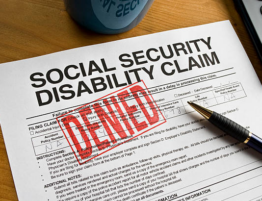 A denied Social Security Disability claim with the word "Denied" stamped on it in red.
