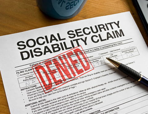 A denied Social Security Disability claim with the word "Denied" stamped on it in red.